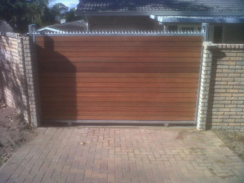 Wooden Sliding Gate With Steel Spikes And Horizontal Slats
