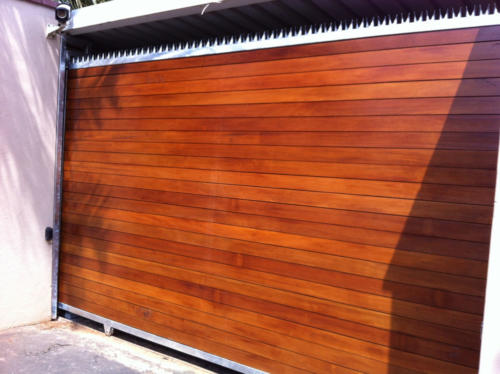Wooden Sliding Gate With Horizontal Slats And Steel Spikes