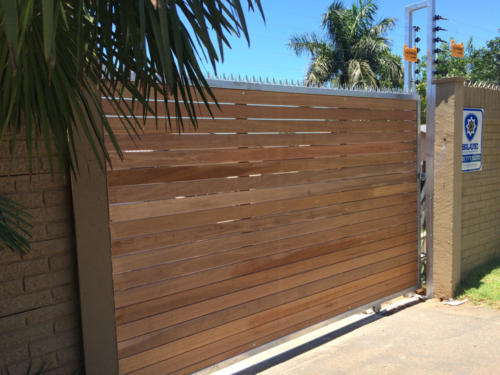 Spiked Wooden Sliding Gate With Horizontal Slats