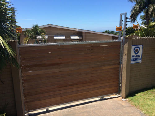 Horizontal Slated Wooden Sliding Gate With Electric Fencing