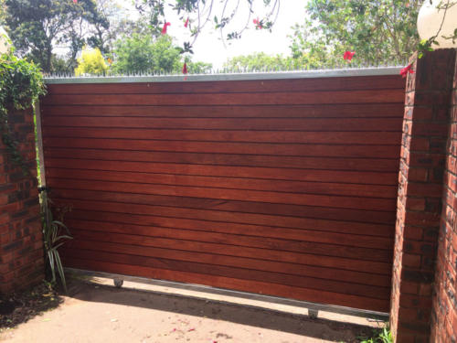 Wooden Sliding Gate With Steel Spikes And Horizontal Slats